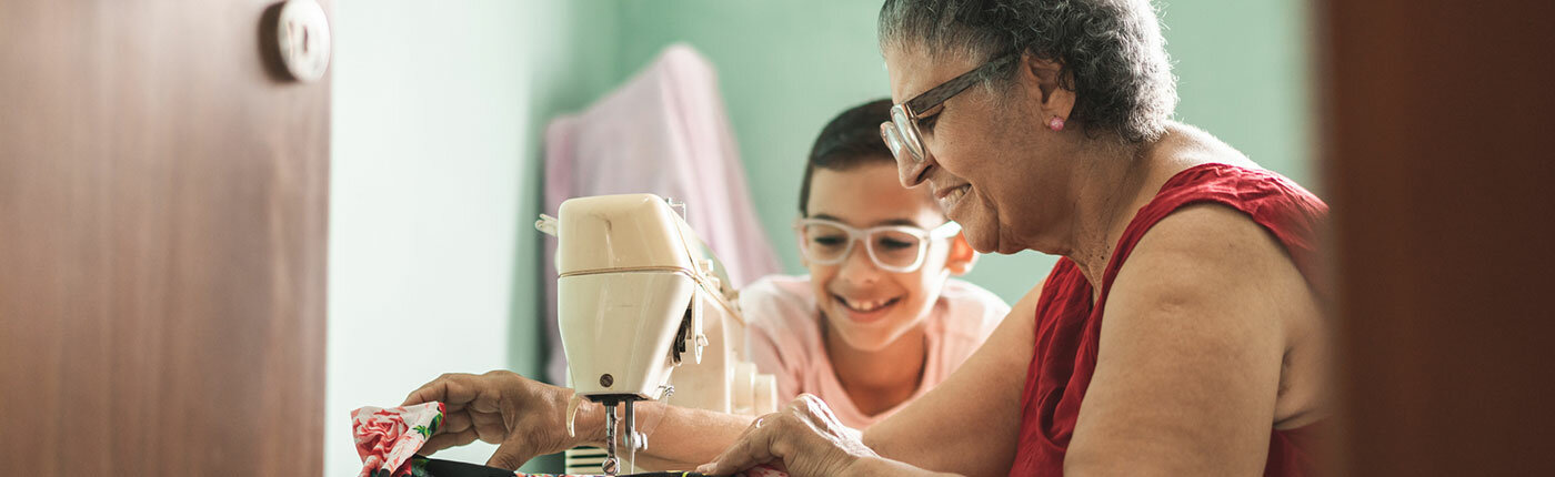 grandma and grandson sewing together