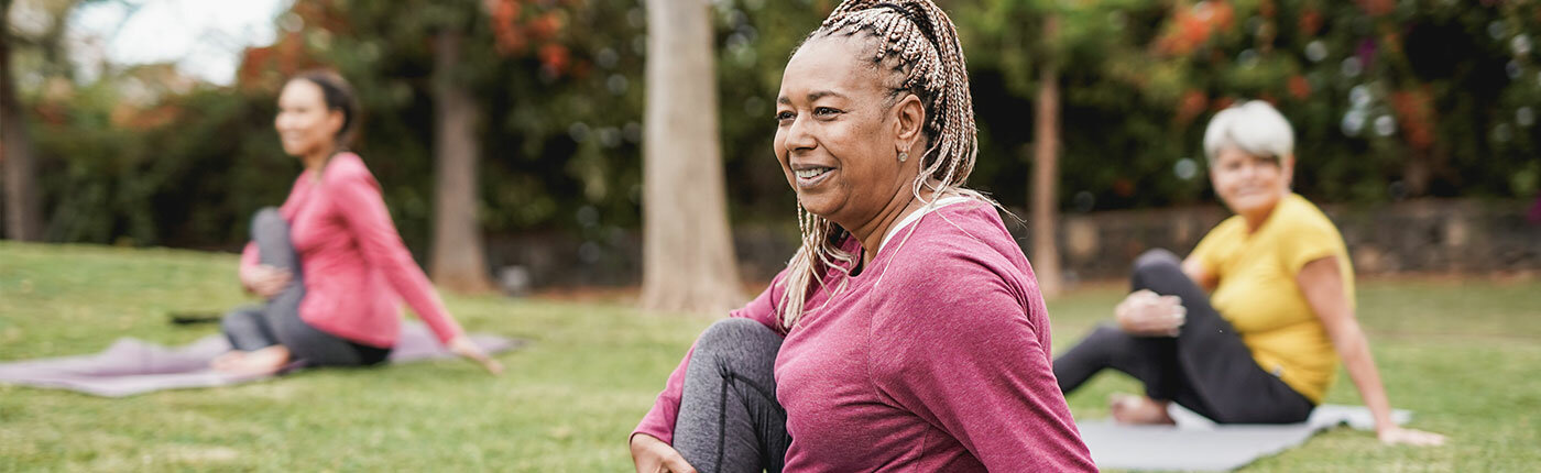 group of older women doing yoga outside