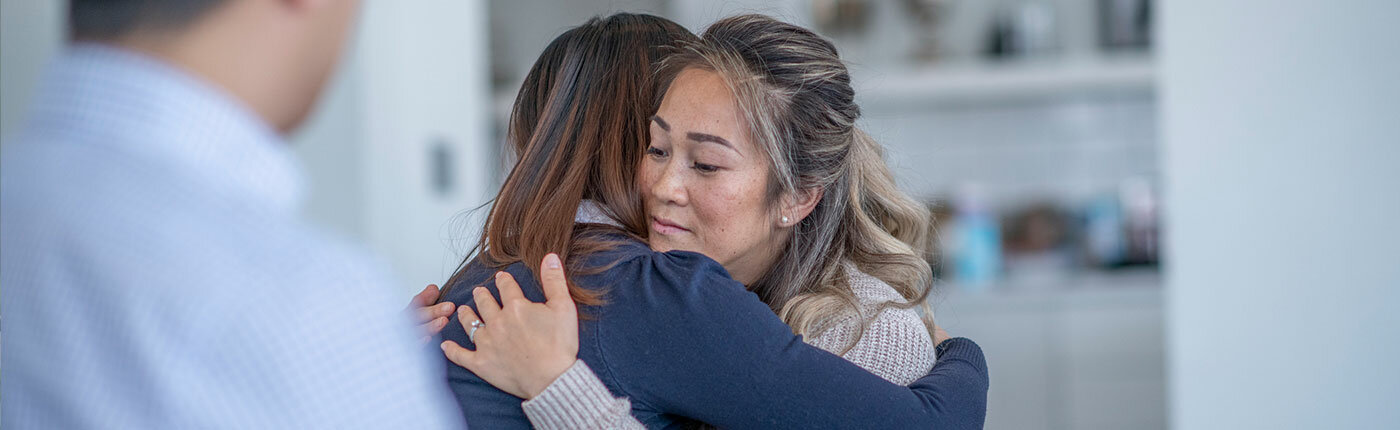 two women embracing during therapy session