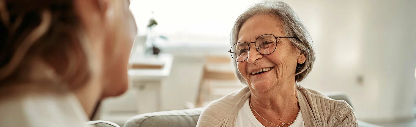 elderly woman smiling at woman