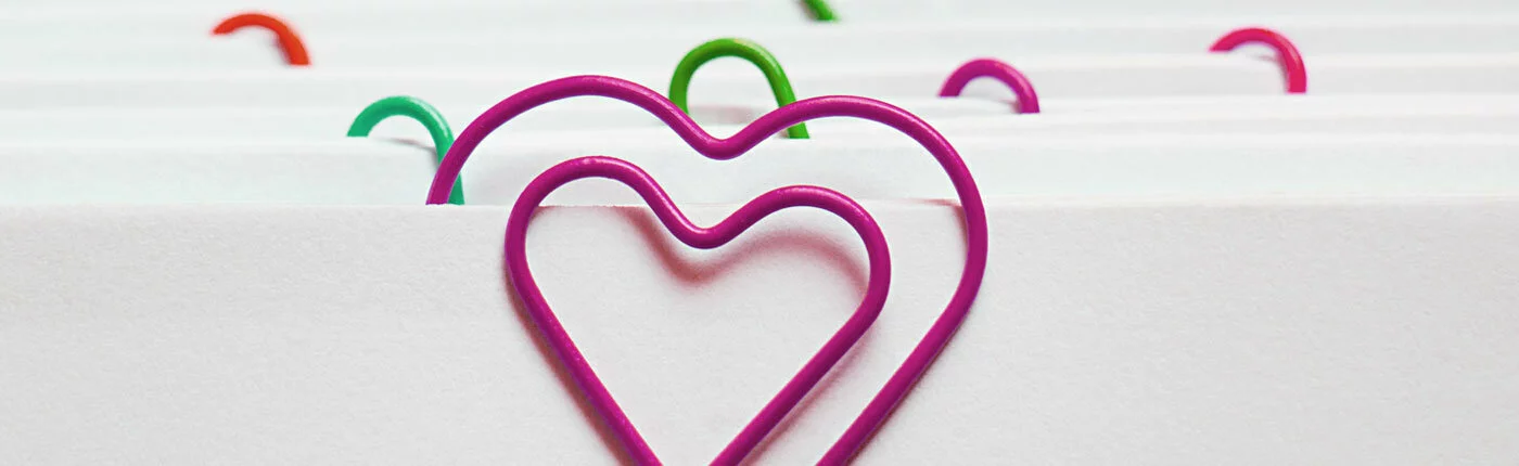 paper clips shaped as hearts in Transitions brand colors