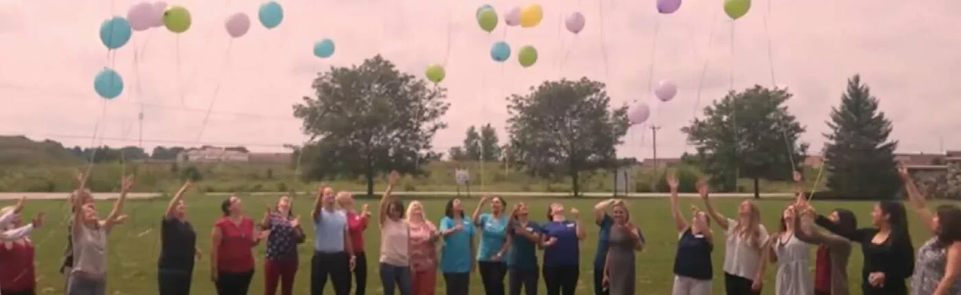 Transitions team releasing balloons into sky