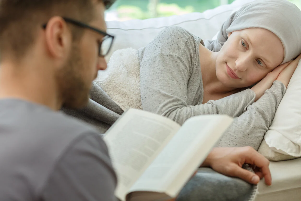 Husband in glasses reading a book to his wife 2025/10/iStock-820510566.jpg 